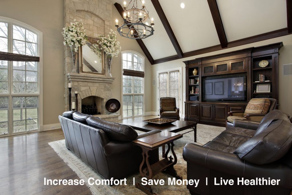 Family room in luxury home with two story stone fireplace